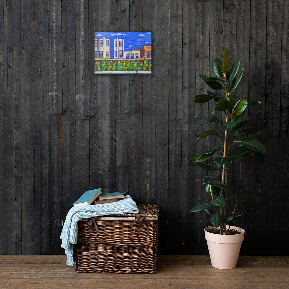 Sunflowers in Queens NYC canvas print, shown hanging on a wall: art-deco brownstones with sunflowers growing along a wrought-iron fence.